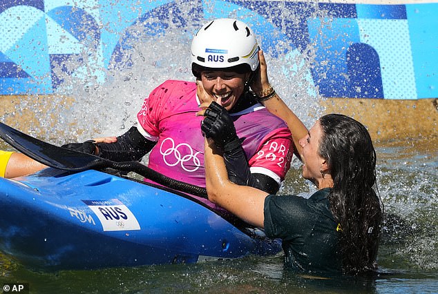 Jessica Fox jumps into the water after the event to celebrate the moment with her sister