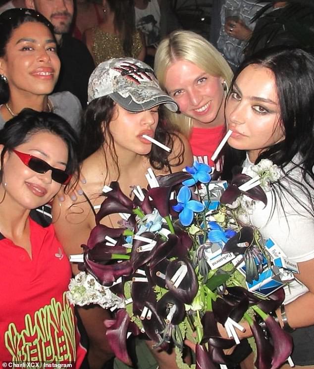 She sipped on a drink before posing with a huge colorful cake and a cigarette-themed bouquet