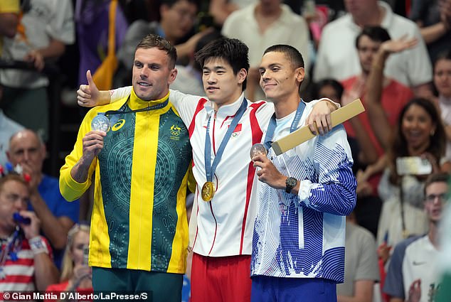 The Chinese star had earlier at the Games easily defeated Australian Kyle Chalmers (left) and Romanian David Popovici (right) in the 100m freestyle final