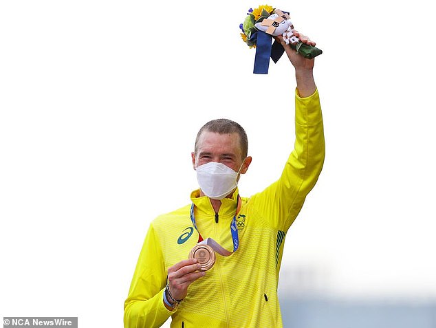 Dennis shows his bronze medal at the Olympic Games in Tokyo. Photo: Tim de Waele/Getty Images