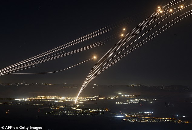 Footage shows the Iron Dome system firing defensive rockets (pictured) to intercept the barrage during ongoing fighting between Israeli forces and Lebanese Hezbollah fighters