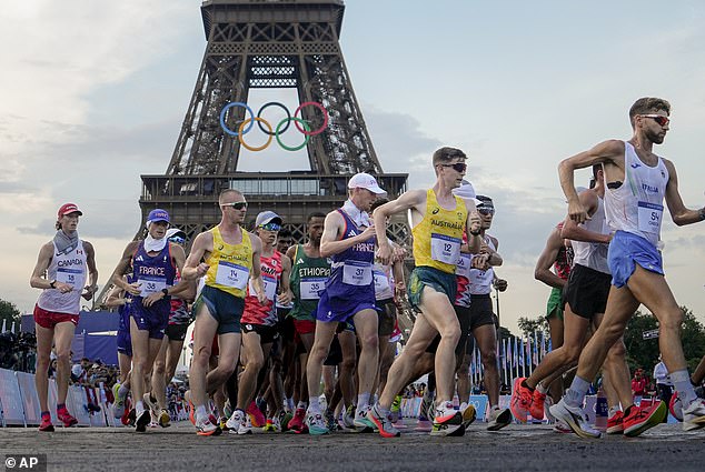 Australians Declan Tingay and Rhydian Cowley (in yellow tops) are pictured competing in the men's race walk in Paris, a race that inspired Alcott to joke with his fans.