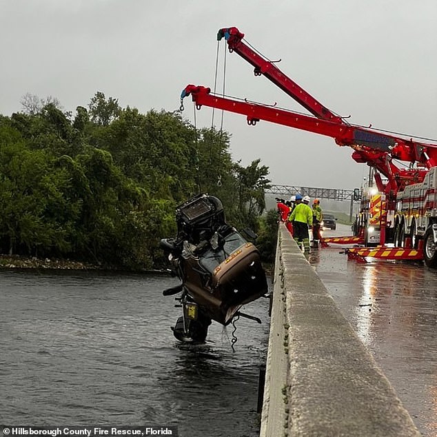 Hillsborough County Fire Rescue is pictured pulling a truck out of the water after it went off the road in the early morning hours of Monday