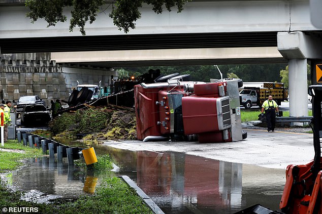 A truck lies overturned on Independence Parkway in Tampa