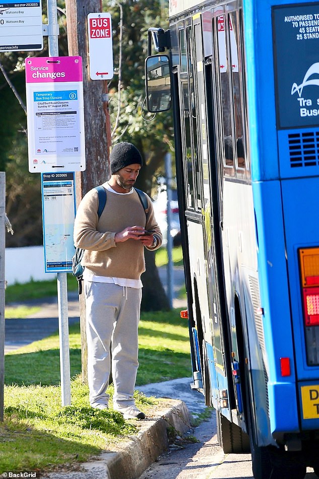 The actor looked like any other commuter as he waited, wearing a camel sweater over a white shirt. He wore loose gray sweatpants and black-and-white sneakers, and a black beanie.