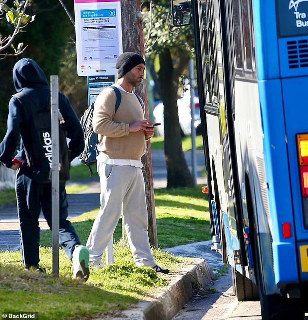 Alex was carrying a backpack that looked very full and was scrolling through his phone before the bus stopped