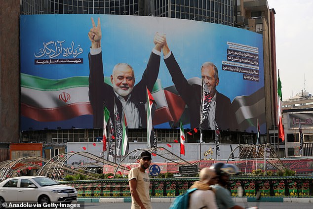 A banner of Iranian President Masoud Pezeshkian, photographed with Hamas Political Bureau head Ismail Haniyeh during the inauguration ceremony, hung on Veliasr Street in Tehran, Iran