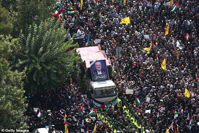 People gather during a funeral procession for Ismail Haniyeh, the political leader of Hamas and his bodyguard who were killed in an assassination in Tehran, Iran