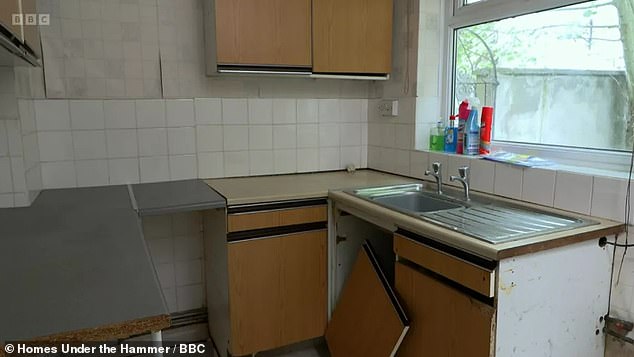 The home's original kitchen had loose tiles and a cupboard door had been completely removed from its hinges