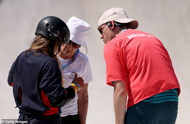 The medical team speaks to Brown over her shoulder after her serious fall