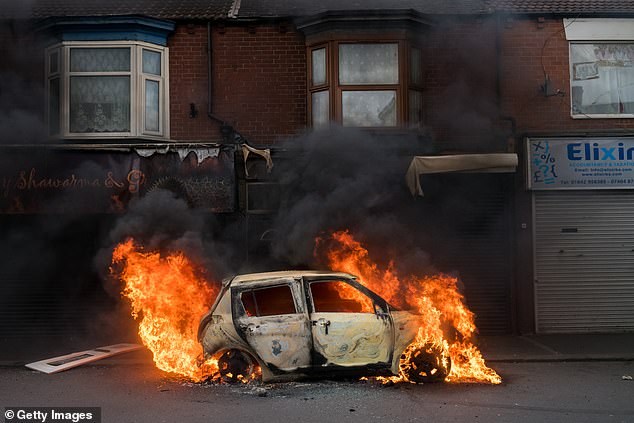 A car burns on Parliament Road after being set alight by far-right activists holding a demonstration in Middlesbrough on August 4, 2024