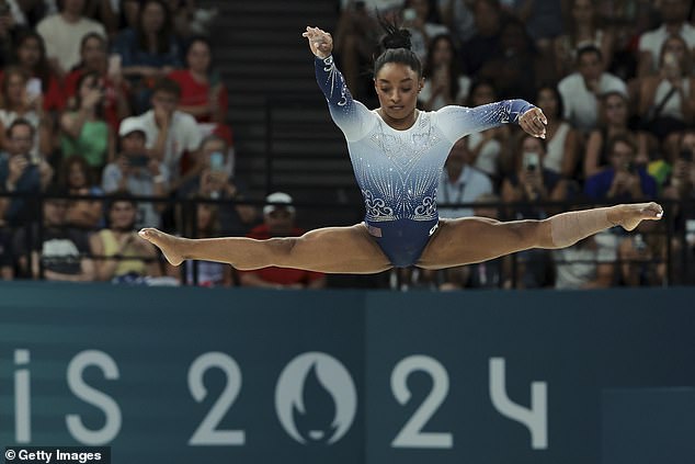 Biles competes in the women's balance beam final on day ten