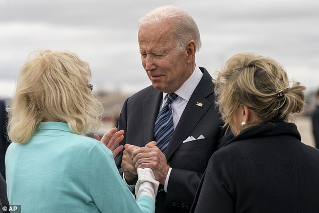 President Joe Biden greets Gov. Tim Walz's mother Darlene (left) and his wife Gwen (right) during a visit to Minnesota in May 2022