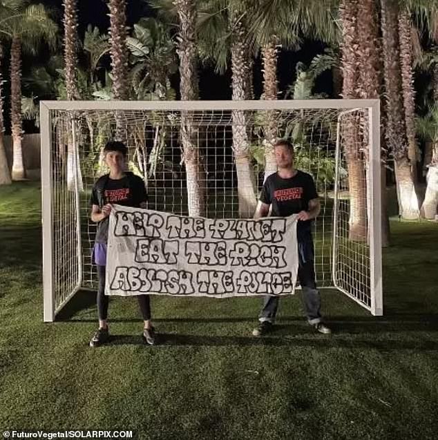 Two members of the group pose in front of the footballer's goal posts in his backyard