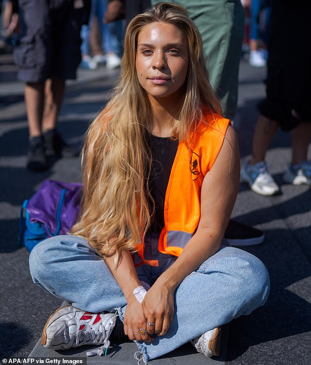 German climate activist Anja Windl is pictured sitting on the tarmac before a march in Vienna, Austria, on September 15, 2023