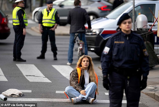 German activist Anja Windl from environmental movement Last Generation blocks traffic with fellow activists at the Aspern Bridge on April 3, 2023 in Vienna, Austria