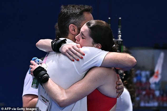 Tearful Team GB star gets a big hug from her coach after missing out on a medal