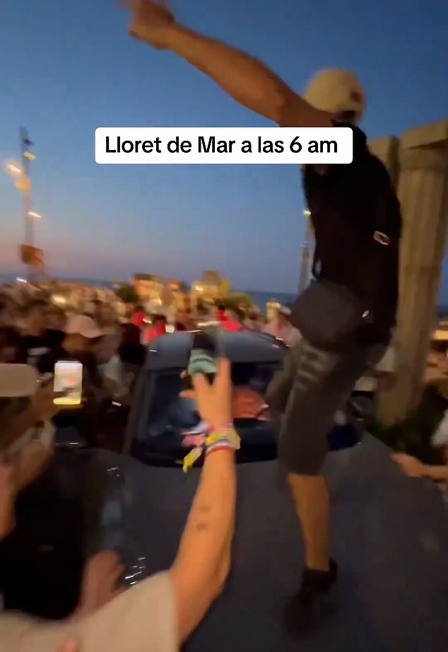 Partygoers decided it was the perfect moment to continue their dance by jumping on the hood of the car