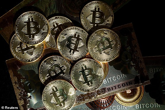 FILE PHOTO: This illustration photo taken in Paris, France, March 9, 2024, shows images of the cryptocurrency Bitcoin. REUTERS/Benoit Tessier/Illustration/File Photo