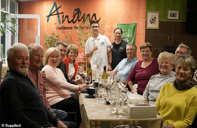 The family has been working mostly seven days a week to slowly pay off the restaurant, which they did last year (pictured, center, Justin and Hue with customers)