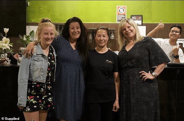 The family was told their sponsor had made a mistake by hiring a worker with an expired visa, meaning they could no longer nominate workers (pictured second from right, chef and owner of Vietnamese restaurant Anam Hua Nguyen, 54, with customers and Justin in the background)