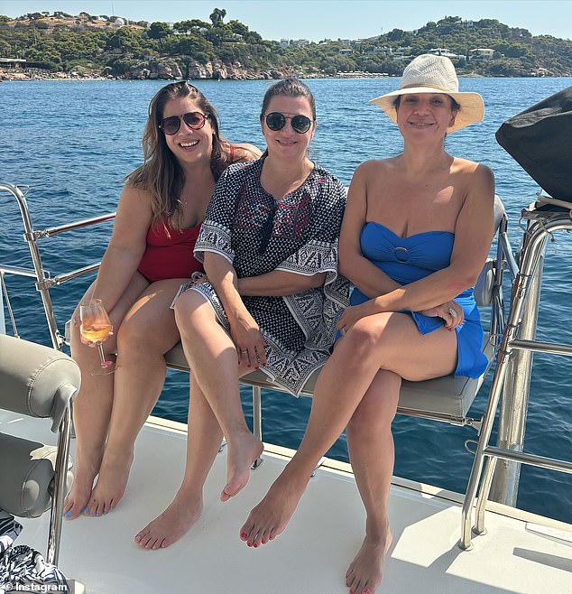 The TV presenter wore a low-cut blue tankini and a sun hat to pose for a photo with two of her friends