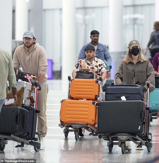 The couple pushed their luggage through the transport hub