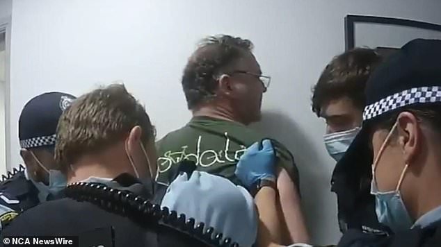 NSW Police handcuffed the former TV presenter in the hallway. Photo: Nine News