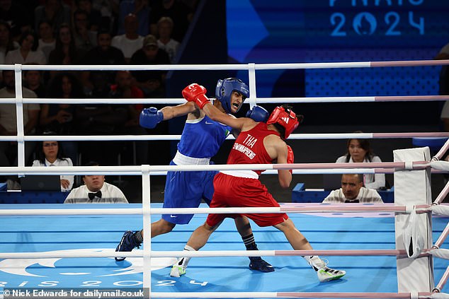 The 25-year-old Algerian boxer won the bout (pictured above) via unanimous decision