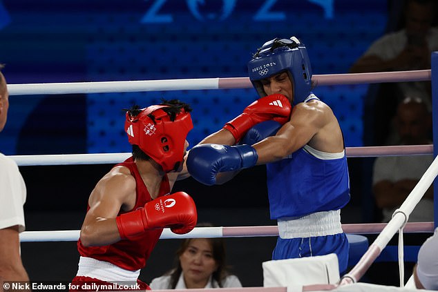 Imane Khelif takes a punch in the face from Janjaem Suwannapheng during the women's 66kg boxing semi-final