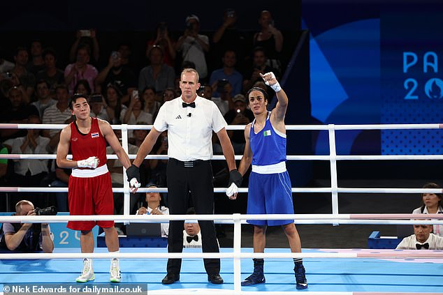 Referee Shawn Reese raises Imane Khelif's arm to announce the winner of the women's 66kg semifinal