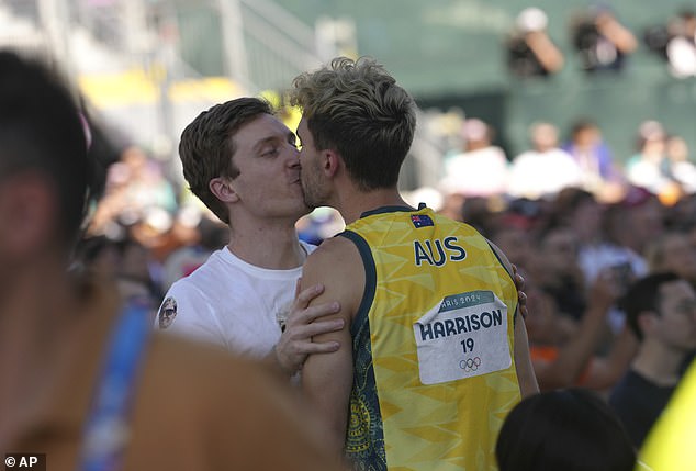 Harrison and his partner are pictured at the Olympics on Monday after competing in the men's bouldering and lead event