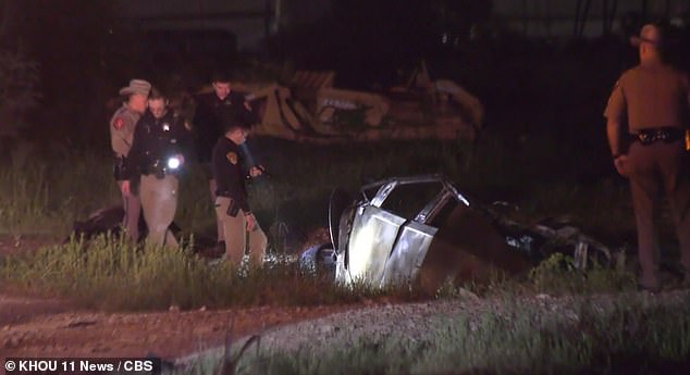 Texas state safety officials (pictured) said the trendy but battered electric car burst into flames after it crashed into a concrete drainage ditch, or culvert, leaving the owner's body and even his truck's license plates and VIN number hidden from the crowd of other vehicles.