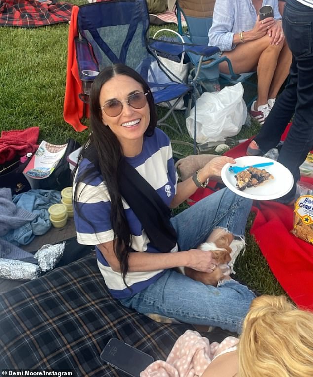 The 60-year-old Brat Packer - who looked like a teenager in her striped T-shirt and jeans - held her beloved two-year-old Chihuahua Pilaf, also known as Little Mouse, as she relaxed on a plaid mattress on the grass