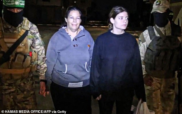 Hostages Shiri Weiss and her daughter Noga (left to right), recently freed, approach a Red Cross vehicle in November 2023