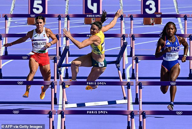 She knocked over the hurdle but went down after losing her balance and landing hard on her side