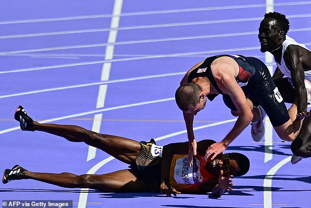 Mills is seen falling to the ground near the end of the men's 5,000 meter race