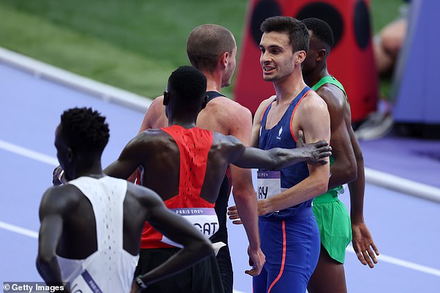 Team France's Hugo Hay and Team Great Britain's George Mills have a chat after competing in the men's 5000m