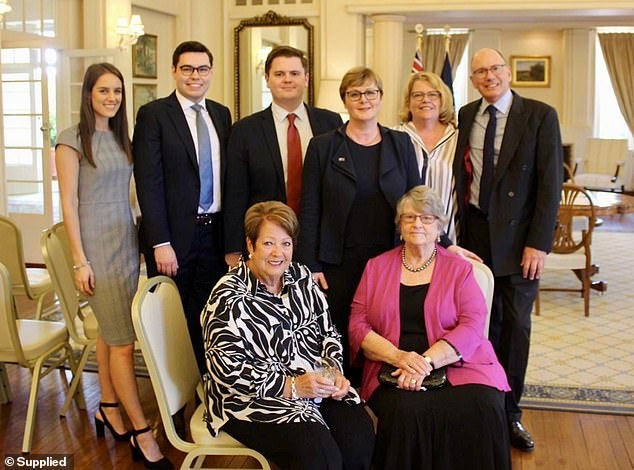 Bruce Lehrmann, second from left, is pictured with Linda Reynolds, third from right in the back row, as she was sworn in as Secretary of Defense Industry in 2019