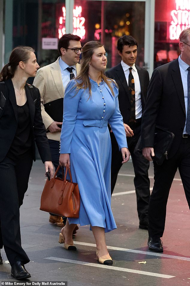 Brittany Higgins is pictured in blue as she arrives at the Western Australian Supreme Court for mediation in March