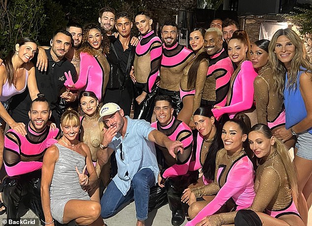 The actor certainly seemed like a social butterfly as he happily posed for a group photo with several attendees, including what appeared to be a group of dancers