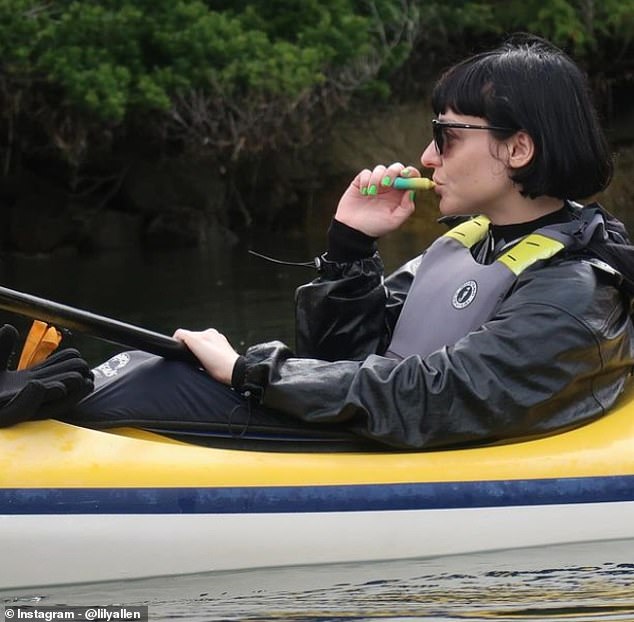 In another photo, the Smile singer bared her teeth in a close-up for the camera, before sharing a snap of her friend Olivia relaxing in her kayak, enjoying a vape as she floated on the water