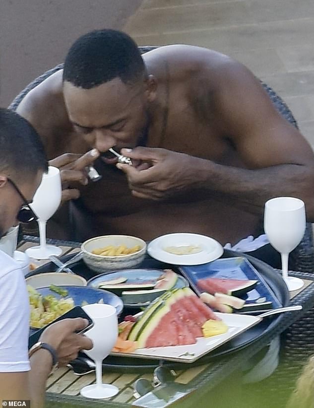 The son of NBA GOAT Michael Jordan appeared focused as he sniffed the powder, while his glamorous bikini-clad partner laughed and chatted next to him, and his friends at the table ate lunch