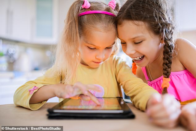 More than half (53 percent) use screens for more than three hours a day when they're not at school, and almost a quarter (24 percent) spend six hours staring at gadgets (file image)