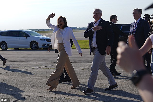 Harris and Walz walk across the Air Force Two ramp to the rally