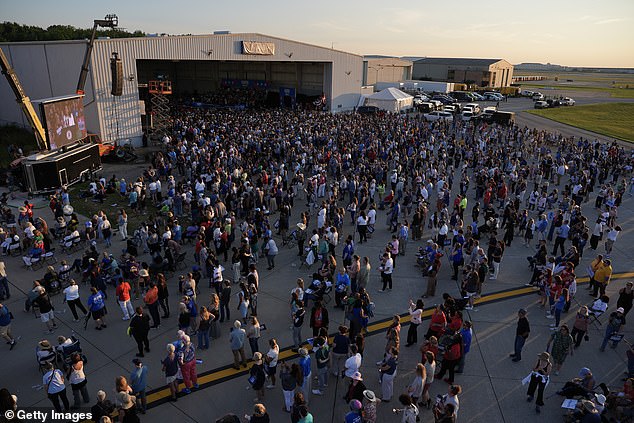 The crowd of 15,000 people poured out of the hangar