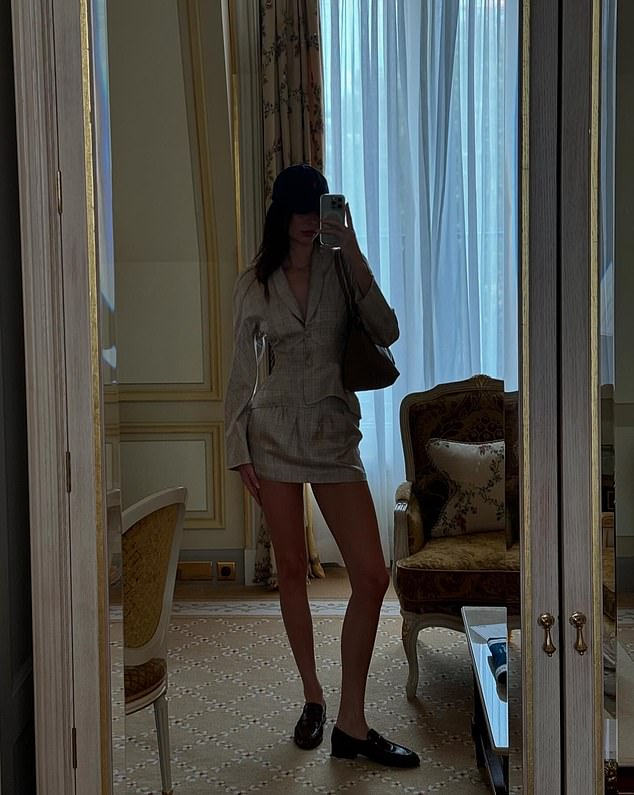 In what appeared to be the same luxurious hotel room, she also shared a mirror selfie she had taken to show off her chic outfit for a day of watching equestrian events at this year's Olympics. The model wore a plunging linen blazer with a matching mini skirt and dark brown oxfords