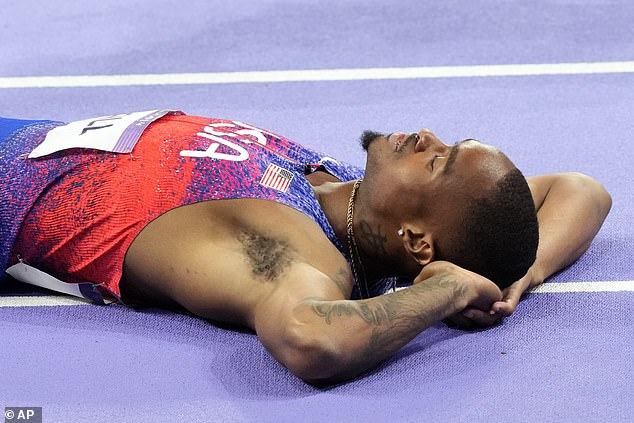 Hall took a moment to enjoy his victory by lying down on the track after his last win in the 400 meters