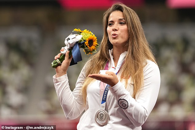 Maria poses on the podium during the medal ceremony for the women's javelin throw at the 2020 Summer Olympics