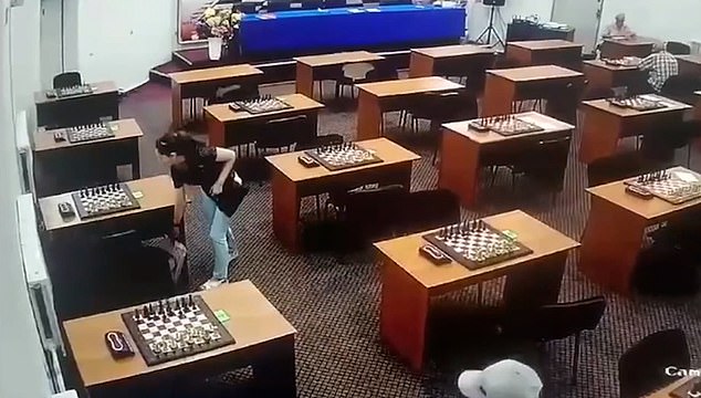 Abakarova first placed a bag under a table as she entered the hall, before walking to the table behind it as she looked around to pour the poison over her opponent's chessboard